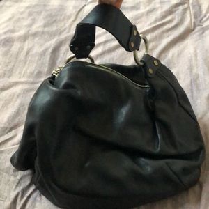 Black leather vintage Juicy Couture hobo bag with chain zipper and dust cover.